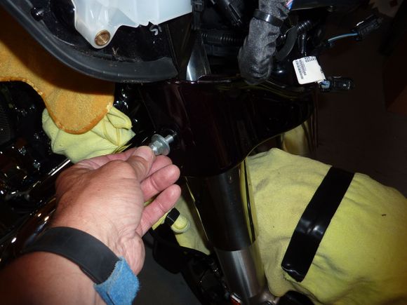 Remove the castle bolts that secure the fairing to the fork legs.  There are two on each side.