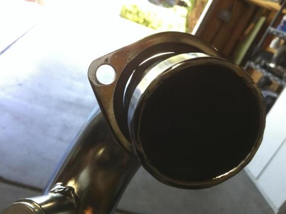 MGS rear header pipe. The bend in the rear is so tight that the pipe is not 100% round, this causes the spring clip in the exhaust flange to not stay in the flange seat.
Fix- Move the clip up to the end of the header pipe, and move up the flange to the exhaust port studs, and tighten up the flange will pull the header pipe to the gasket and seal. Check and tighten with 1/4" drive 20-50-100 miles when engine is at temp.
