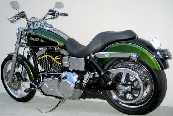 **Front End**
*H.D. 2006 Wide Glide 21" front wheel 
*H.D. Billet Fork Slider Dust Covers
*H.D. Chrome Lower Fork Sliders
*Kuryakyn Front Axle Nut Covers  
*H.D. 2008 Screamin Eagle Dyna front turn signal mounts 
*H.D. Classic Chrome Brake Caliper Insert 

**Hand Controls**
*H.D. Aileron Hand Grips
*H.D. Chrome Switch Cap Kit 
*Routed control wiring inside handle bars

**Tank**
*H.D. 2008 Screamin Eagle Dyna Gauges
*H.D. Smooth LED Fuel Gauge 
*Tank lift 1.60"

**Engine**
*H.D. Screamin Eagle Yellow 10mm spark plug wires 
*Home made spark plug wire supports
*Relocated horn 
*Installed banana jack on bottom of coil cover for battery tender

**Foot Controls**
*H.D. 2005 Forward control kit 
*H.D. 2006 Polished Stainless Steel Gear Shift Linkage *Removed the original shift lever without removing the primary
*H.D. 2007 Screamin Eagle Springer foot pegs 
*H.D. 2007 Screamin Eagle Dyna Polished Stainless Steel Footpeg Mounting Pins 
*Grinded down rear foot peg stops so pegs will tilt in more when in the up position

**Rear End**
*H.D. 2007 Street Glide Air Shocks 
*Modified lower belt guard
*H.D. Script Rear Axle Cover Kit 
*H.D. Tinted turn signal lenses 
*Painted turn signal reflector and internal housing flat black
*Custom Chrome lay down pyramid license plate mount *Trimmed license plate to fit inside mount
*Kuryakyn Deluxe Smoked Tail Light 
*Painted LED light face plate and inside of lens sides flat black
