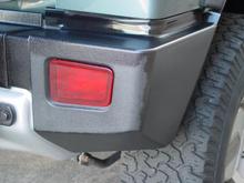 Applying Wipe New to the right side rear bumper. The transformation from old to new is amazing!