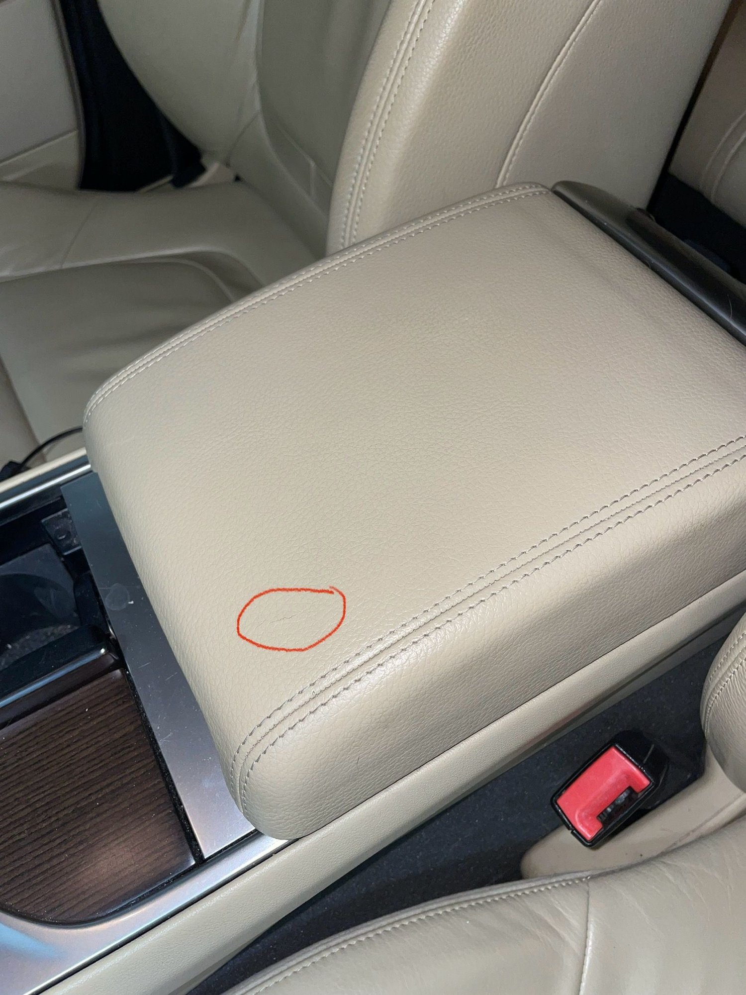 Small tear inside red circle. 