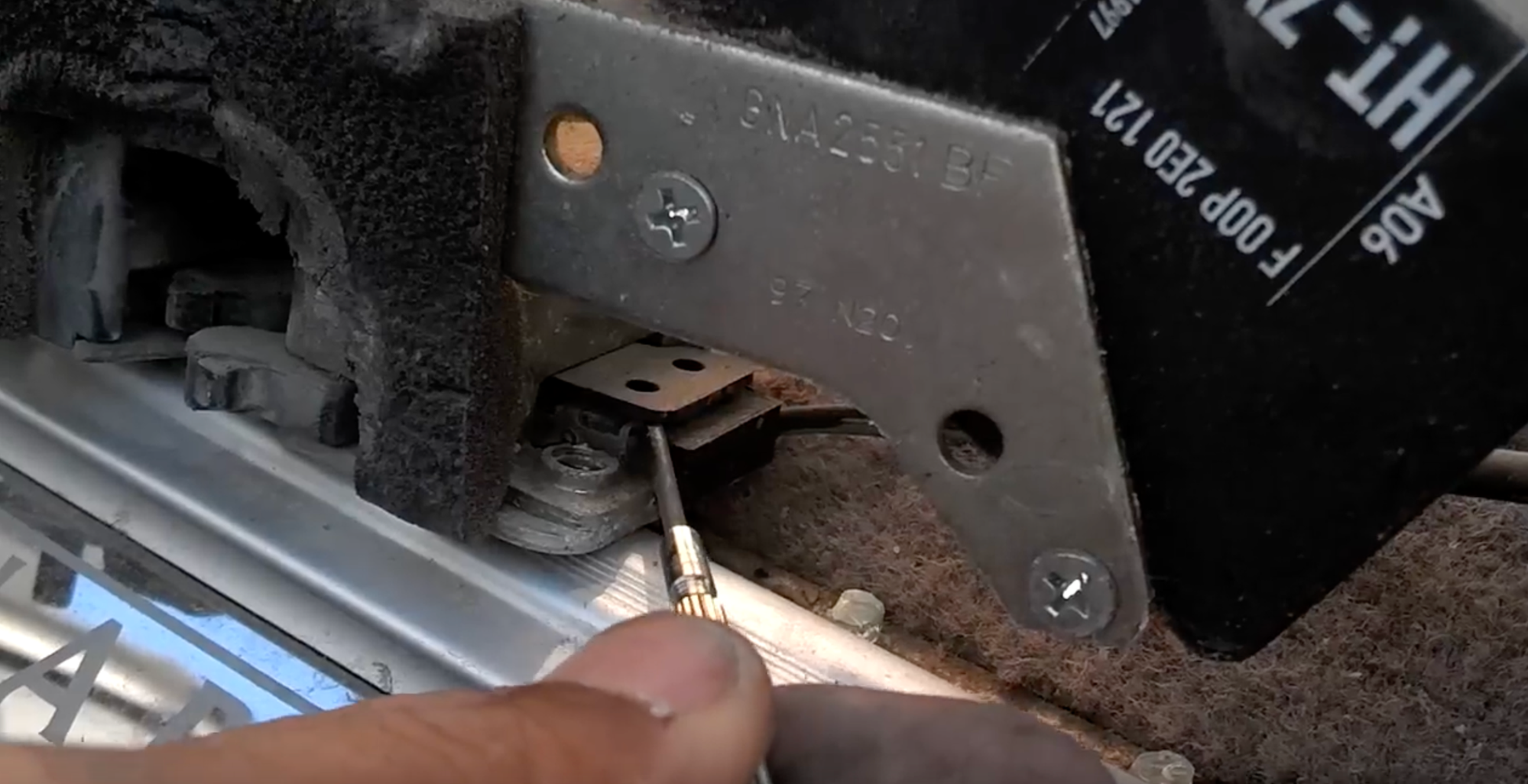 Pry up to release the microswitch and then slide it out from under the tab above.