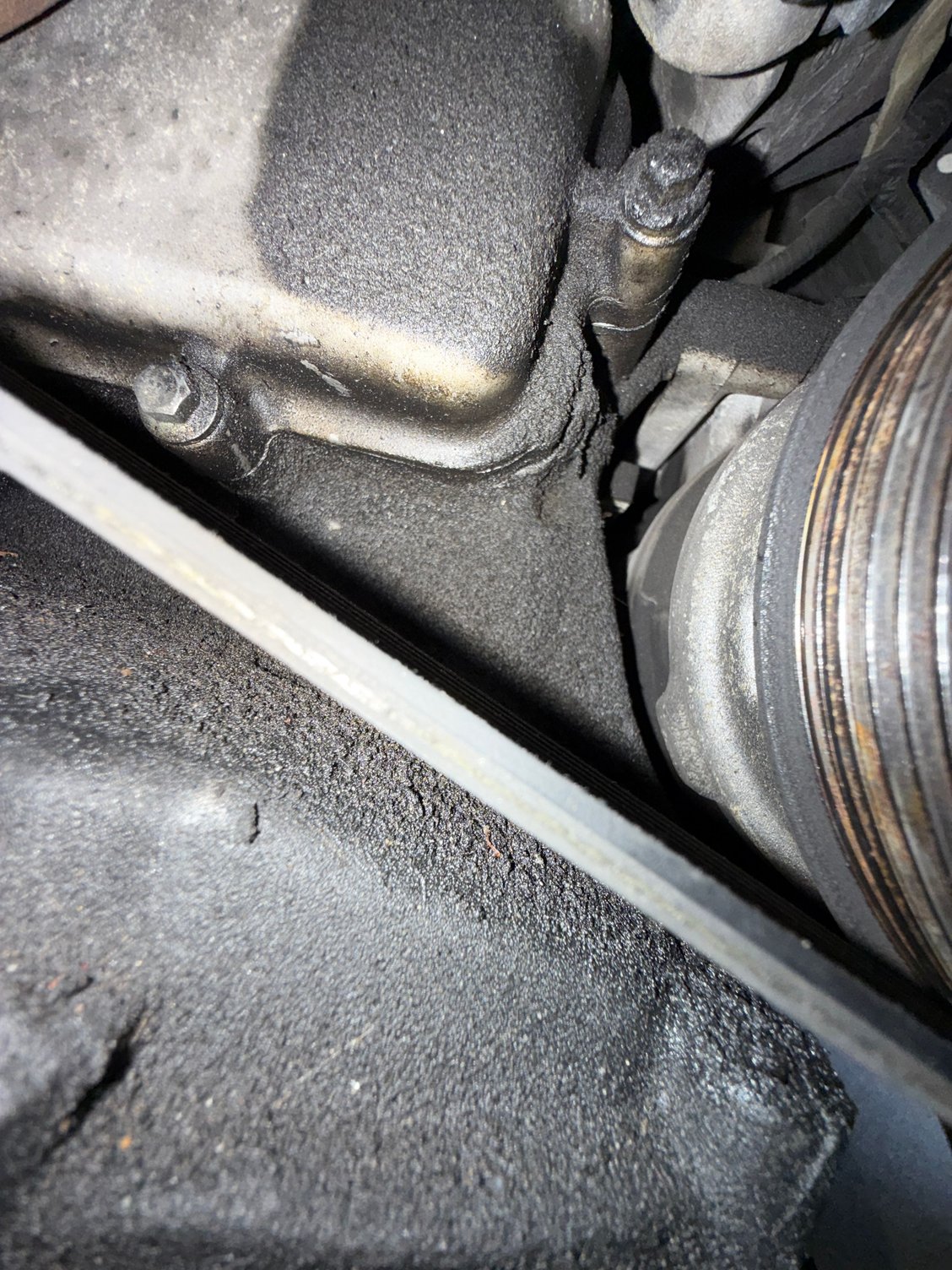 Oil seeping past upper-right bolt.