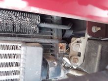 This is on the driver side in the vent area below the front bumper. Those 2 screw holes( 6MM) were where a bracket was that held this up in place. Looking for this bracket if someone has a dead xjr. I imagine it could be for several years.