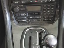The XJ8 has broken interlock in transmission selector (not broken gearbox as advertised), often found after ignorant, ham-fisted wannabes wrench gear lever out of Park without first engaging footbrake.  I bought it with its fault preventing any stick selection other than R, N, D . . . the broken internal bits stopping the stick from engaging P or any transit over to manual side of J-Gate . . . nowt other than one position fore and aft of where you see the stick here, in 'N', which allows start. 