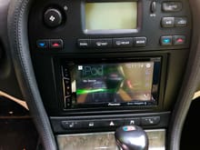 The Pioneer installed, with sub volume control visible on driver side center console wall, in the drivers footwell.