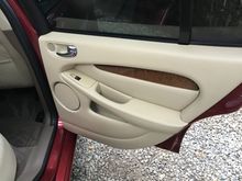 Each door is leather with wood trim.