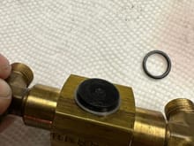 That silver lining at the underside of this valve is simply a flat “coil” lock washer.  It wraps around the plastic valve handle about 1-1/2 times.  You’ll need a hook or maybe small knife to start prying the end out of position, then slowly snake the rest of it off.  