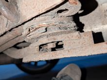 One of the rotten rear subframe front bushes.you can see how rusty the sbframe is too.