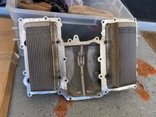 This is the V6….There are 4 torx bolts each intercooler holding it to the cover. Probably a gasket too where the water feeds poke through the cover each side.
However masking up as you planned should work. 