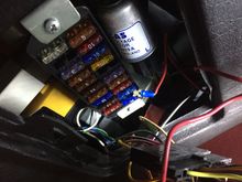 That red wire coming out of the fuse box has a inline fuse and goes to the large flat plug the mystery box plugs into