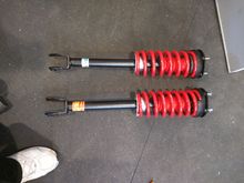 Side by side of stock and Bilstein hybrid front units