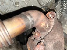 This damn stud to the EGR pipe broke off. If I could just remove the bolt on the other side, I could remove the EGR pipe and then work on removing that stud. However, I can't get ANY purchase on this damn bolt on the other side of that flange to be able to remove the EGR pipe. Does anyone have any idea what tool and what angle would best help here? I have tried socket-wrenches, spanners, off-set spanners, and none seem to work for me. Either they collide with the damn pipe an