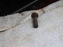 This Bolt goes through the Bango on the Top of the Closing Panel on the right hand side of the Closing Panel (UK) Car.
There is a hole drilled through the middle of the Bolt up to the point where it meets another hole drilled crosswise through the body of the bolt,