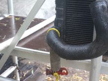 Home made Rad Hose Wrangler to Twist the Bottom Hose to break the Seal, which works on the 'Dutch Windlass' principle, or you could do it properly and use an Oil Filter Strap removal Wrench.