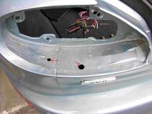 The 2 marked holes open behind the bumper not into the trunk so don't need to be sealed.