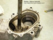 Steve Hannes: The mainshaft has no visible means of bearing load adjustment. It is fixed by the inner case dimensions. The tapered bearing races at either end are fitted to the case housings. That means then, load is set by bearing positions on the shaft. Those are pressed on. There are standards in the industry for endplay on a shaft assembly like this, so in the instance of a transfer case rebuild (where this posting is going), an endplay tolerance of .001" or less is probably acceptable. For the countershaft, it first uses a "thickness" thrust washer to "ballpark" fit into the case. Then there is an external nut with a crush collar threaded on to the countershaft end that is torqued (to an unknown spec) to achieve proper load on the tapered bearings.
***** more info:   http://jagmotorproject.blogspot.com/2007/02/motor-project-17-transfer-time.html     *****