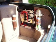 The 5-amp stack, plus tweeter amp under the battery - To the left, that brown cylinder is ... the perks of driving open air: mobile, 3-stogie humidor...aaah