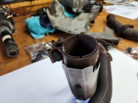 Reversed clamp on exhaust from rear cat.