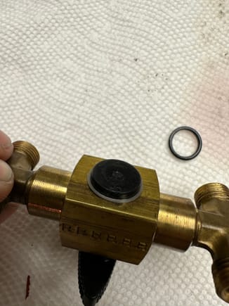 That silver lining at the underside of this valve is simply a flat “coil” lock washer.  It wraps around the plastic valve handle about 1-1/2 times.  You’ll need a hook or maybe small knife to start prying the end out of position, then slowly snake the rest of it off.  