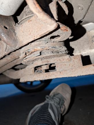 One of the rotten rear subframe front bushes.you can see how rusty the sbframe is too.