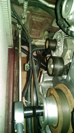 The crankshaft locking tool goes behind, and under, the swaybar.