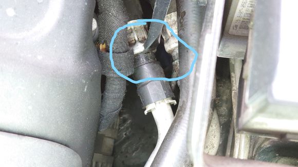 Gently prodded the soft rubber bit of the connection away from the crimped end with this large screwdriver indicated and it started squirting in that location. 
