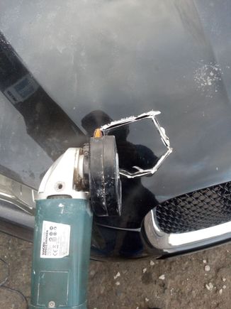 I made a template by tracing round the "retaining catch assembly" on the replacement bonnet then carefully hacked out the appropriate section of the upper skin.