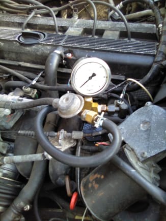 pressure gauge, a piece of fuel injection hose and various fittings