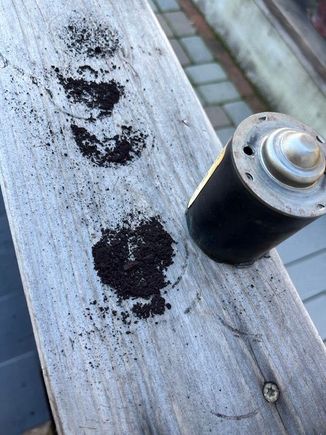 Don't breathe in the dust!  Knocking the crud out of the motor cover

