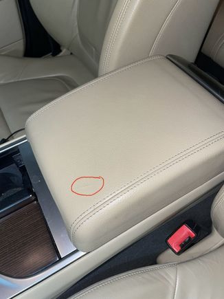 Small tear inside red circle. 