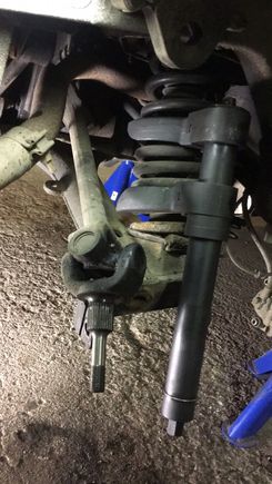 Spring compressor.. not expensive and a very useful tool..