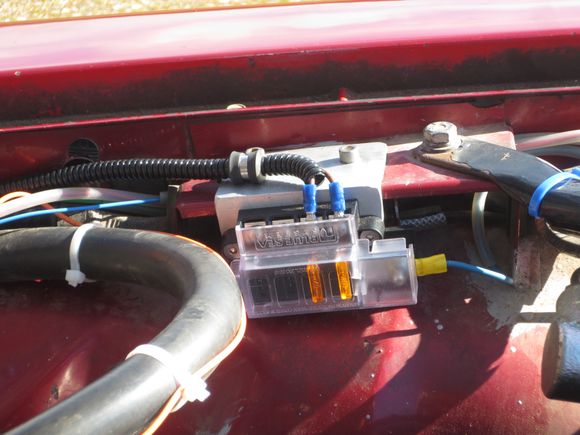 Extra fusebox slot all ready for washer pump relay power feed. This box is for the twin circuits to the main electric fan, one automatic from the water pump inlet switch, one cabin-switched, with two completely separate circuits and relays. It is fed from the firewall post.