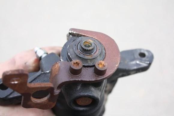 The e-brake lever has been removed.  You can see the weather seal there.  You will need to remove this.  A small screw driver will allow you to slide under this seal and it will pop right off.