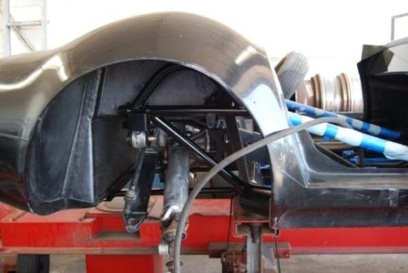 While waiting for the glue and resin to cure, we started putting the suspension and rear end into position.  Here, the differential and half shafts have just been installed.  the next step is the lateral links, trailing links and toe rods.