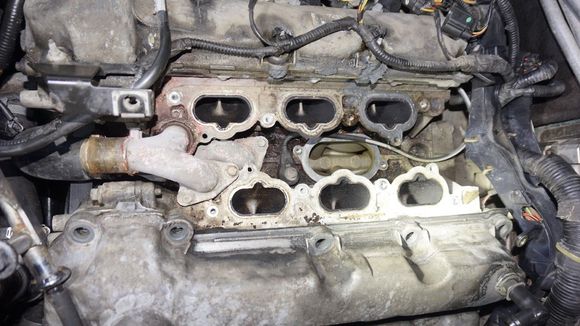 After removing a whole lot of parts (incl. air-intake and fuel-injection-unit) you get access to that upper hose-flange-bit, which is screwed onto the engine block...