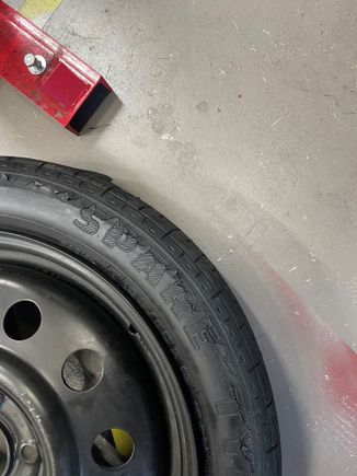 Dry-rotted OEM spare.