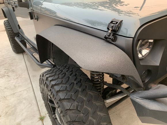 Custom cut fenders and then sprayed with Raptor bed liner for fade resistant and durability (mirrors also sprayed)