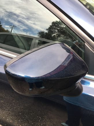 Passenger side mirror is starting to warp near attachment and the black trim on mirror has gotten wavy.