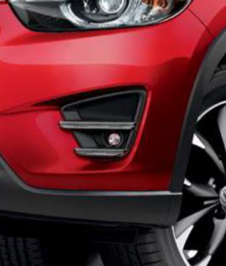 Factory fog light on 2016.5 Mazda CX-5, showing the surround piece that holds the light in place within the bumper fascia.