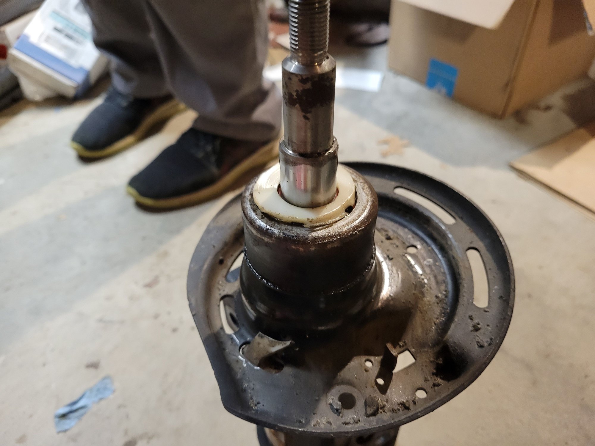 The right strut was even worse than the left.  That white piece is broken and probably happened from bottoming out.  Not much gas left.  And it was leaking.