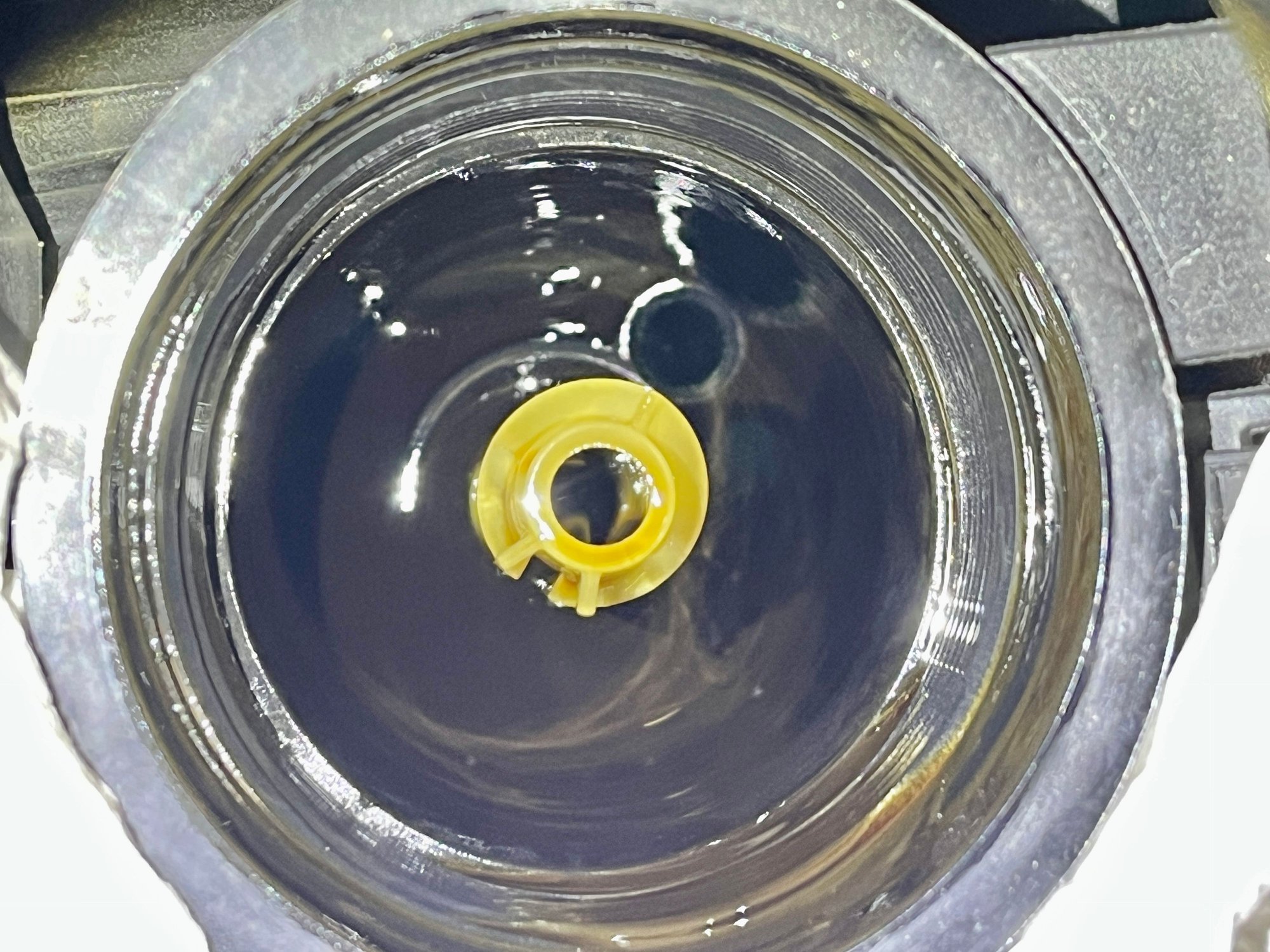 Hole in bottom of oil filter housing.