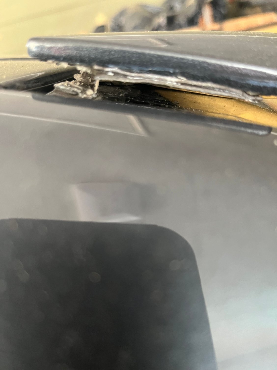 Loose window spoiler with multiple failed tapes. 