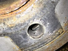 Something inside of the hub. Has been scratched (lighter area) by longer OEM bolt.