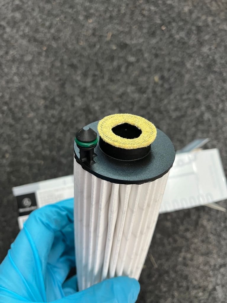 Insert this end of filter aligning post with hole in filter. Then in stall cap.