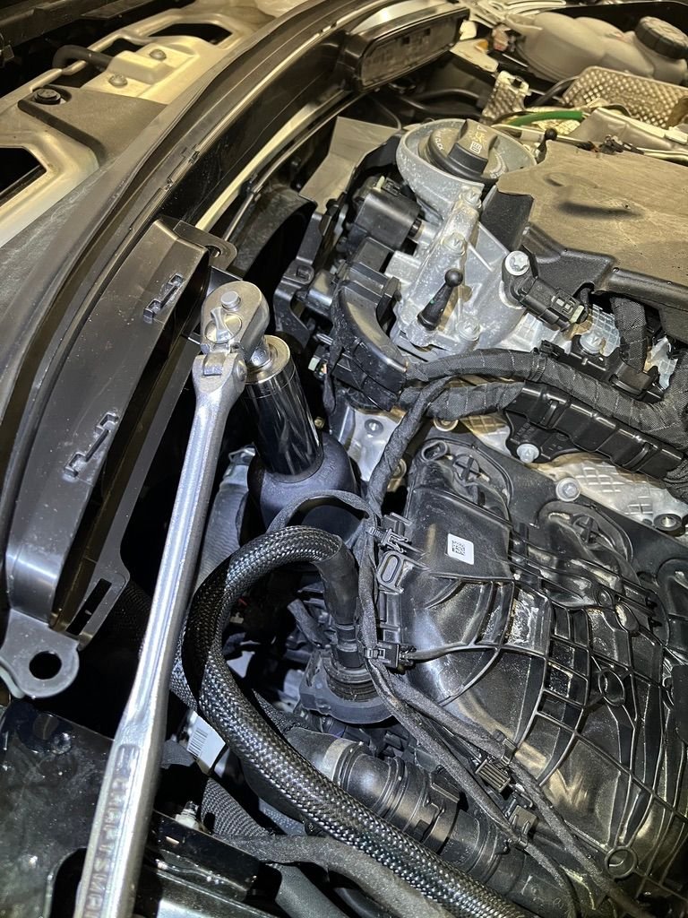 Removing oil filter cap.