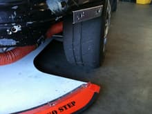 Splitter under car.  View of aluminum dzus flange attached to front fender