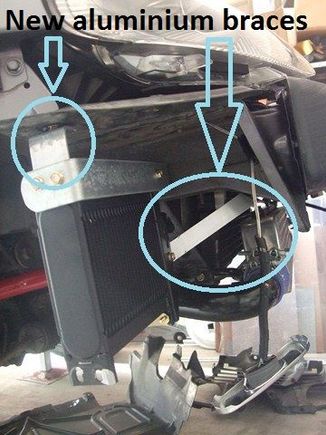 Right diagonal aluminium bracket mounts to a tie-down hook bolt-point and bottom of oil cooler to provide horizontal stability.