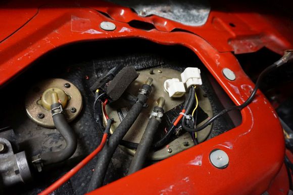 Glory shot of the Walbro 190 HP fuel pump which is directly powered from the battery. The original fuel pump wires are used to switch the relay, while the thicker gauge wires power the pump.