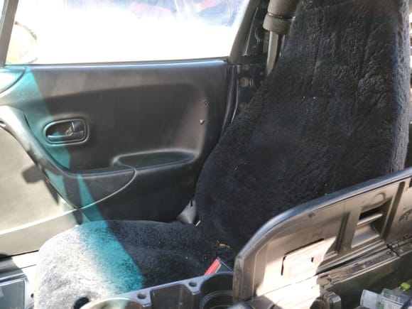 Note the seat cover and the broken hinge on the center console.